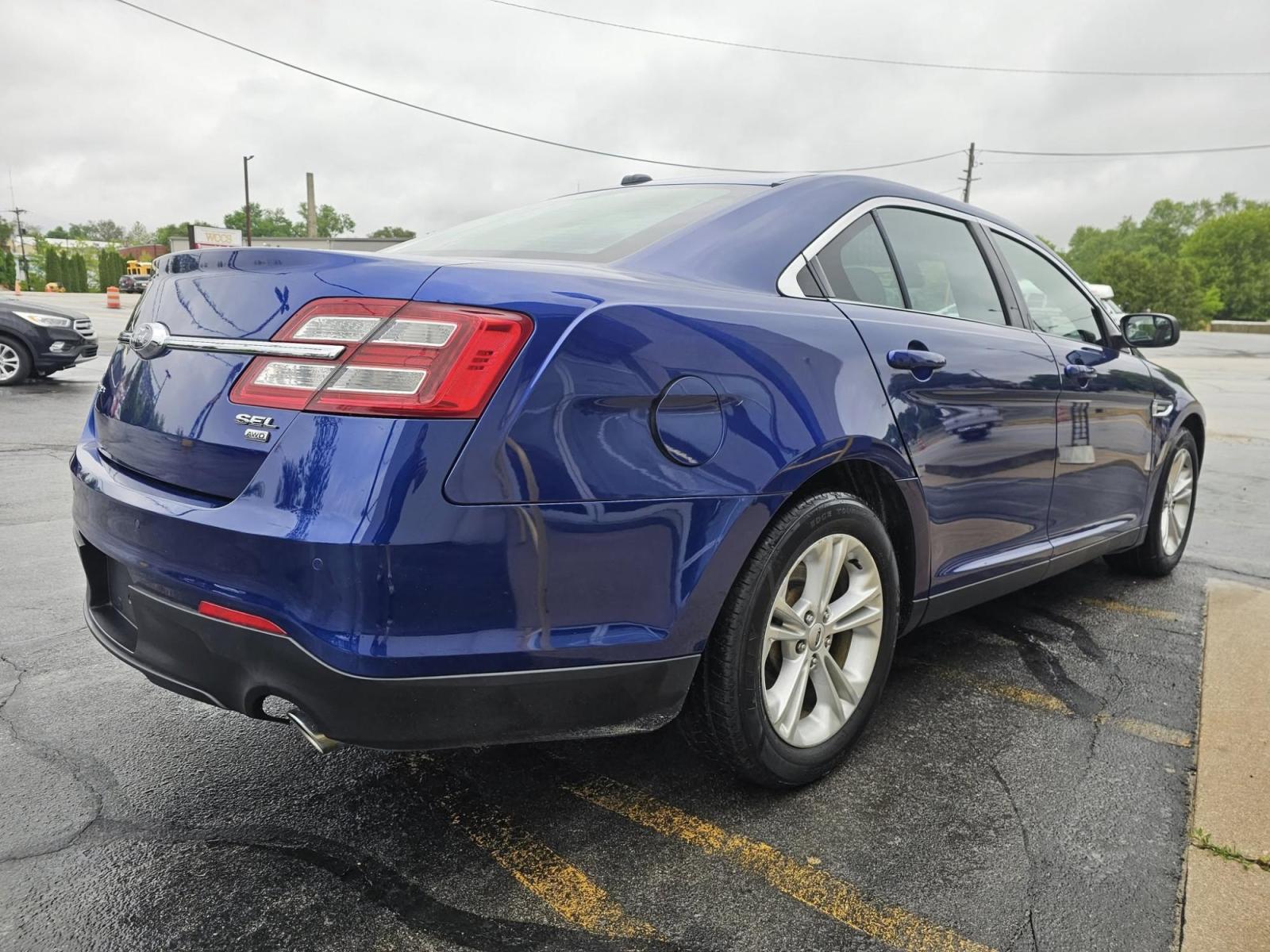 2015 BLUE /BLACK Ford Taurus SEL AWD (1FAHP2H86FG) with an 3.5L V6 DOHC 24V engine, 6-Speed Automatic transmission, located at 502 South Main Street, Columbia City, IN, 46725, (260) 244-4645, 41.151382, -85.490578 - Photo#2